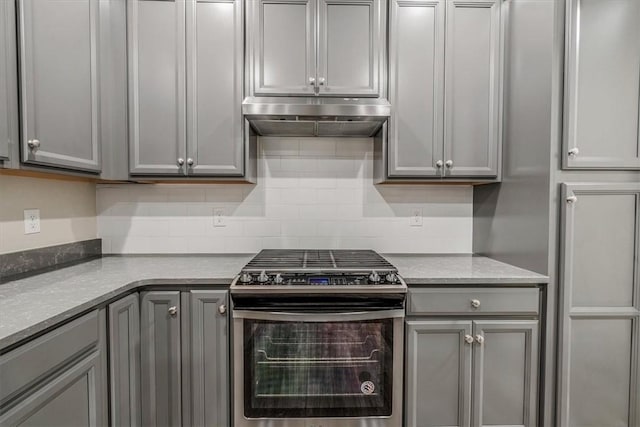 441 Roebling Ct, Cranberry Twp, PA 16066 - kitchen with stainless steel range with gas stovetop, gray cabinetry, under cabinet range hood, and decorative backsplash