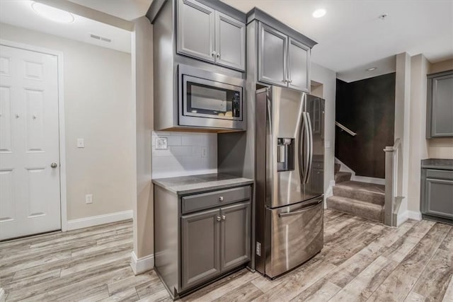 441 Roebling Ct, Cranberry Twp, PA 16066 - kitchen with stainless steel appliances, gray cabinets, light wood-type flooring, decorative backsplash, and recessed lighting