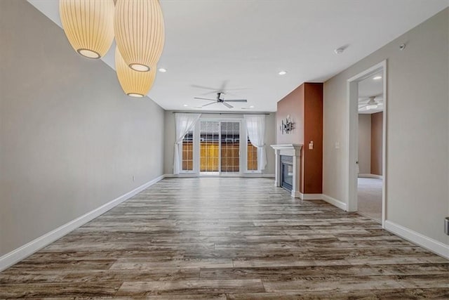 441 Roebling Ct, Cranberry Twp, PA 16066 - unfurnished living room featuring a ceiling fan, a glass covered fireplace, wood finished floors, and recessed lighting