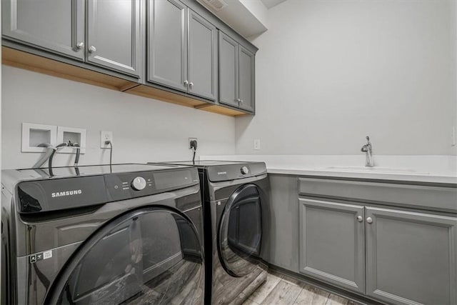 441 Roebling Ct, Cranberry Twp, PA 16066 - laundry room featuring washer and dryer, cabinet space, and light wood-style flooring