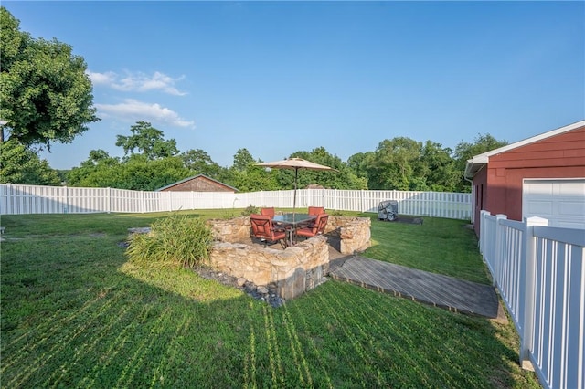 563 Edward St, Derry Twp, PA 15650 - fenced backyard with an outdoor fire pit and a patio
