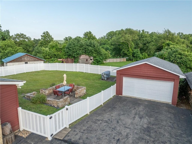 563 Edward St, Derry Twp, PA 15650 - fenced backyard featuring a detached garage and an outdoor structure