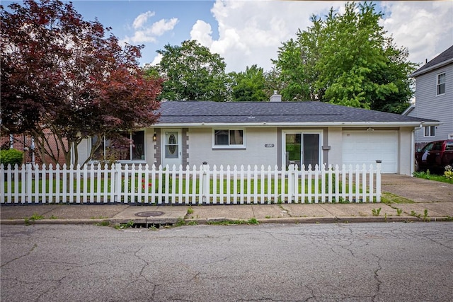 1220 Mcminn St, Aliquippa, PA 15001 - view of front of home with an attached garage, a fenced front yard, concrete driveway, and brick siding