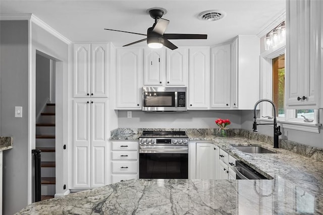 124 Heath Dr, Economy, PA 15005 - kitchen with stainless steel appliances, white cabinets, and light stone counters