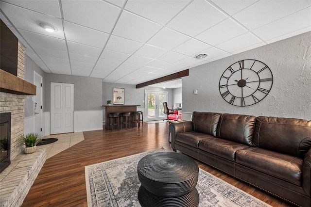 124 Heath Dr, Economy, PA 15005 - living room with a paneled ceiling, wood finished floors, a textured wall, and a fireplace