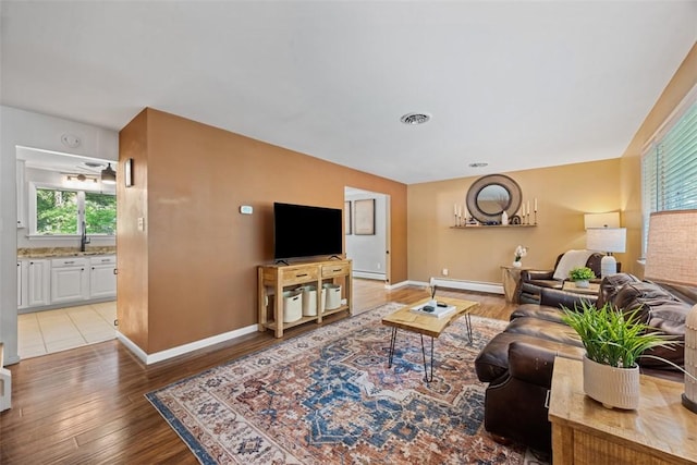 124 Heath Dr, Economy, PA 15005 - living area with a baseboard radiator, light wood finished floors, and a baseboard heating unit