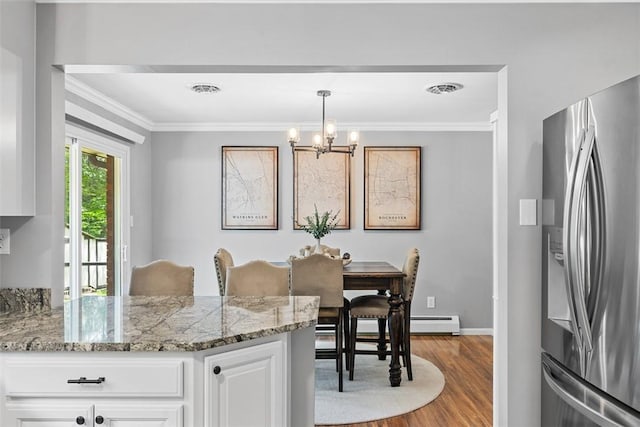 124 Heath Dr, Economy, PA 15005 - dining area with ornamental molding, wood finished floors, a chandelier, and a baseboard radiator