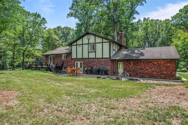 124 Heath Dr, Economy, PA 15005 - rear view of house featuring a chimney, a wooden deck, a lawn, and brick siding