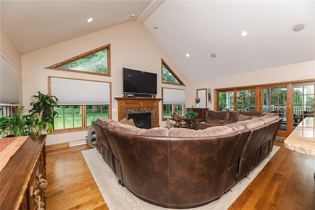 391 Browns Hill Rd, Middlesex Twp, PA 16059 - living area with high vaulted ceiling, a high end fireplace, wood finished floors, plenty of natural light, and recessed lighting