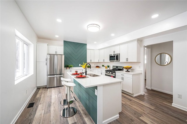 322 Crane Ave, Rear, Beechview, PA 15216 - kitchen featuring stainless steel appliances, light countertops, white cabinets, wood finished floors, and recessed lighting