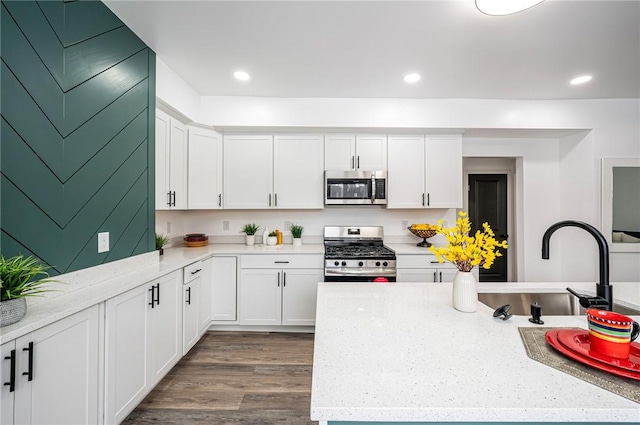 322 Crane Ave, Rear, Beechview, PA 15216 - kitchen featuring appliances with stainless steel finishes, white cabinets, dark wood-style flooring, light stone countertops, and recessed lighting