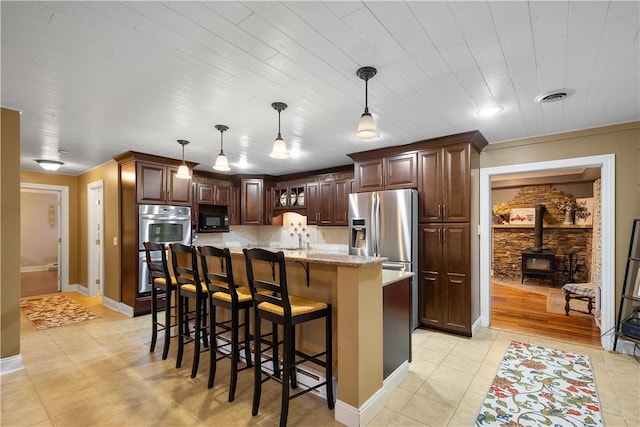 102 Klages Rd, Donegal, PA 15376 - kitchen with appliances with stainless steel finishes, a breakfast bar, backsplash, a center island, and hanging light fixtures