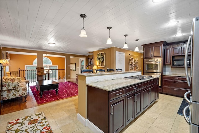 102 Klages Rd, Donegal, PA 15376 - kitchen featuring appliances with stainless steel finishes, light tile patterned floors, open floor plan, pendant lighting, and a kitchen island