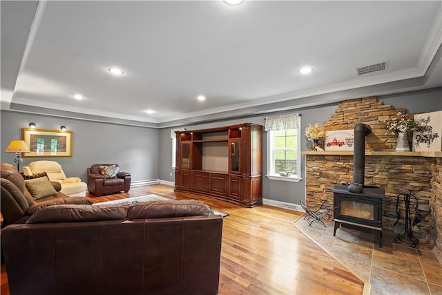 102 Klages Rd, Donegal, PA 15376 - living area with ornamental molding, a baseboard radiator, a wood stove, light wood finished floors, and a tray ceiling