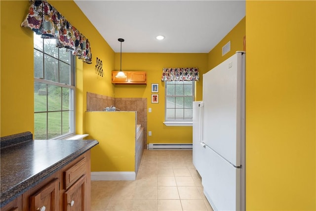 102 Klages Rd, Donegal, PA 15376 - kitchen with baseboard heating, freestanding refrigerator, dark countertops, light tile patterned flooring, and pendant lighting