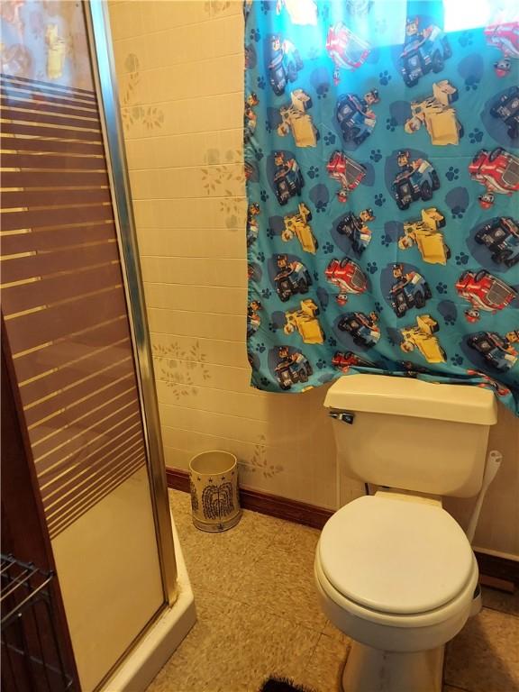 406 Walnut St, Sugarcreek, PA 16343 - bathroom featuring baseboards and a shower stall