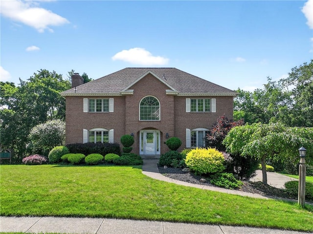 2455 Dogwood Dr, Franklin Park, PA 15090 - colonial inspired home featuring a chimney, a front yard, and brick siding
