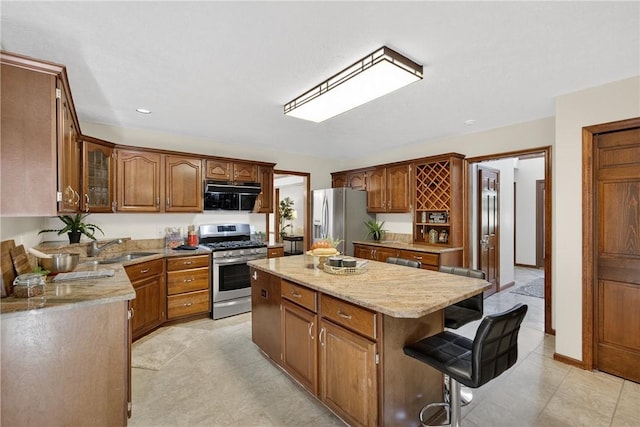 2455 Dogwood Dr, Franklin Park, PA 15090 - kitchen featuring stainless steel appliances, a center island, glass insert cabinets, light stone countertops, and a kitchen breakfast bar