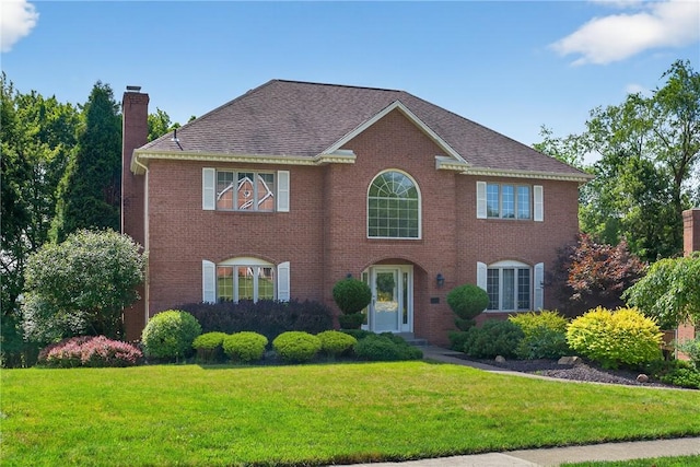 2455 Dogwood Dr, Franklin Park, PA 15090 - colonial house featuring a chimney, a front yard, brick siding, and roof with shingles