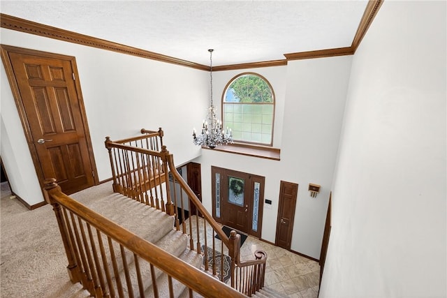 2455 Dogwood Dr, Franklin Park, PA 15090 - foyer with a chandelier, light colored carpet, crown molding, and a textured ceiling