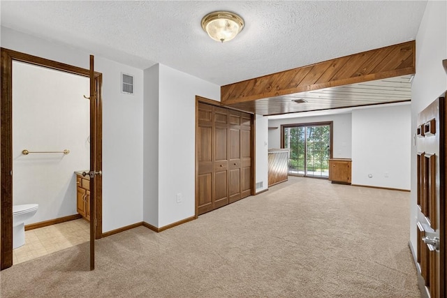 2455 Dogwood Dr, Franklin Park, PA 15090 - unfurnished bedroom featuring carpet flooring, a textured ceiling, ensuite bathroom, a closet, and access to outside