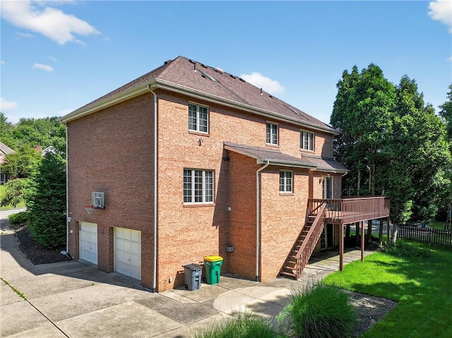 2455 Dogwood Dr, Franklin Park, PA 15090 - rear view of property with stairway, a garage, brick siding, concrete driveway, and a deck