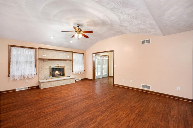 1664 N Main St, Center Twp, PA 16001 - unfurnished living room featuring vaulted ceiling, a ceiling fan, dark wood finished floors, and a brick fireplace