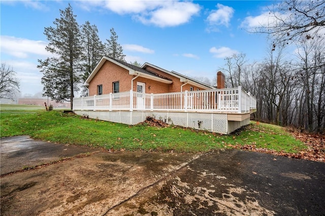 1664 N Main St, Center Twp, PA 16001 - view of property exterior featuring brick siding, a yard, and a wooden deck