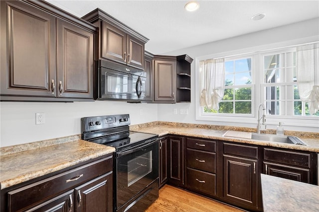 1504 Lombard Cir S, Strabane, PA 15301 - kitchen with black appliances, dark brown cabinetry, plenty of natural light, light countertops, and recessed lighting