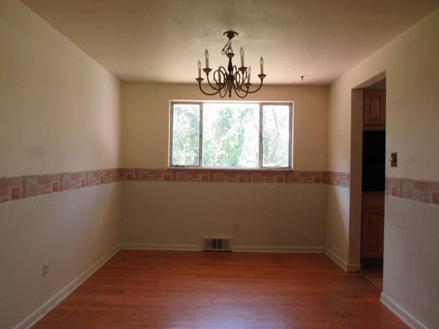 438 Saratoga Dr, Pleasant Hills, PA 15236 - unfurnished dining area featuring a chandelier and wood finished floors