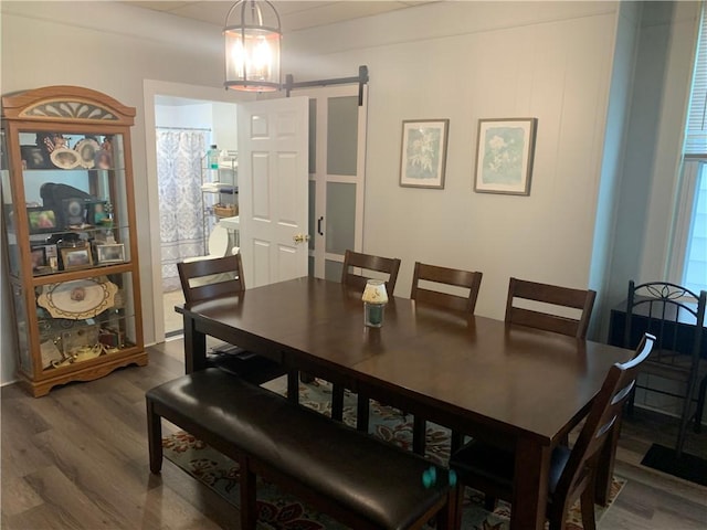 74 Wilson St, Etna, PA 15223 - dining space with wood finished floors, a barn door, and a chandelier