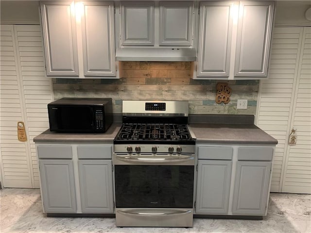 74 Wilson St, Etna, PA 15223 - kitchen with stainless steel gas range oven, under cabinet range hood, black microwave, and gray cabinetry