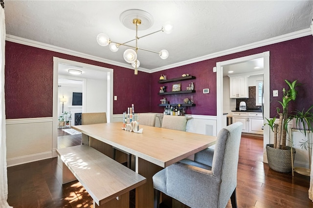 590 Kenilworth Dr, Mt Lebanon, PA 15228 - dining area featuring dark wood-style flooring, crown molding, wainscoting, a chandelier, and a textured wall