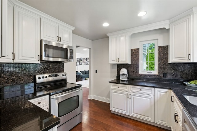 590 Kenilworth Dr, Mt Lebanon, PA 15228 - kitchen with appliances with stainless steel finishes, white cabinetry, dark wood-type flooring, backsplash, and dark stone counters