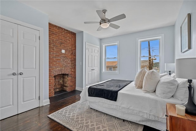 4228 Post St, Lawrenceville, PA 15201 - bedroom with wood finished floors, a brick fireplace, and a ceiling fan