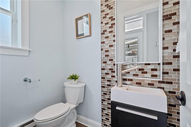 4228 Post St, Lawrenceville, PA 15201 - half bathroom featuring baseboard heating, vanity, and decorative backsplash