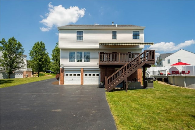 206 Buckeye Ct, Nottingham, PA 15330 - back of house with stairs, an attached garage, asphalt driveway, a wooden deck, and a yard