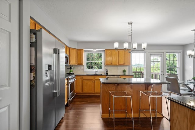 206 Buckeye Ct, Nottingham, PA 15330 - kitchen featuring premium appliances, dark wood-type flooring, a chandelier, tasteful backsplash, and a center island