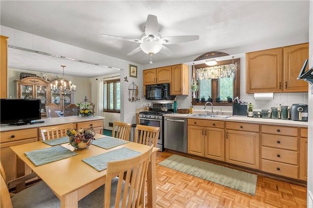 1031 Fiddleback Dr, Kennedy Twp, PA 15136 - kitchen featuring stainless steel appliances, plenty of natural light, a ceiling fan, and tasteful backsplash