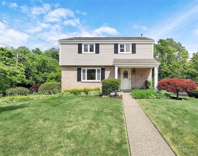 1031 Fiddleback Dr, Kennedy Twp, PA 15136 - view of front of house with a front yard and brick siding