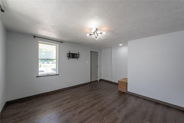 430 Kennedy Ave, East Vandergrift, PA 15629 - spare room with a textured ceiling and dark wood-style floors