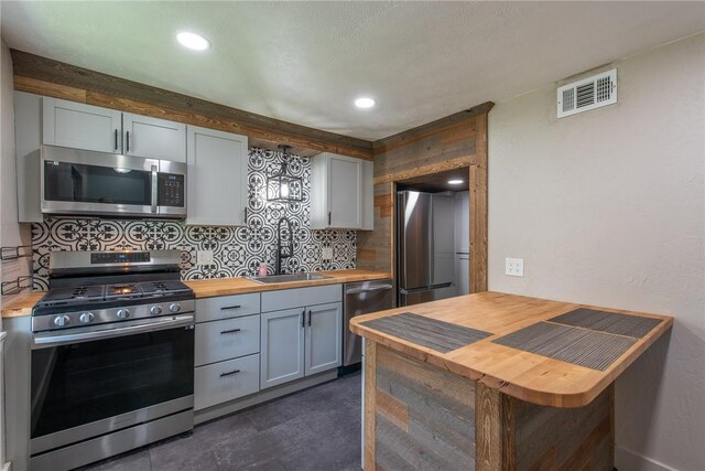 430 Kennedy Ave, East Vandergrift, PA 15629 - kitchen with appliances with stainless steel finishes, wood counters, tasteful backsplash, recessed lighting, and gray cabinets