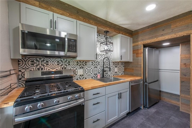 430 Kennedy Ave, East Vandergrift, PA 15629 - kitchen with appliances with stainless steel finishes, wooden counters, and tasteful backsplash