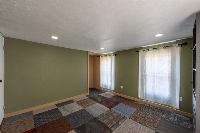 430 Kennedy Ave, East Vandergrift, PA 15629 - spare room with plenty of natural light, recessed lighting, a textured ceiling, and dark colored carpet