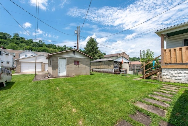 430 Kennedy Ave, East Vandergrift, PA 15629 - view of grassy yard featuring an outdoor structure, a garage, and stairway