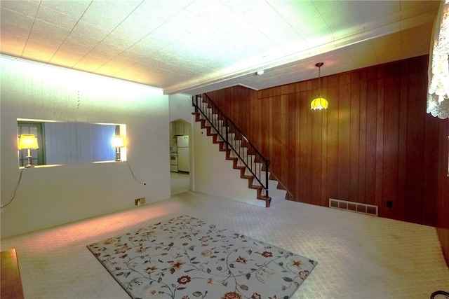 608 Shady Ave, Charleroi Boro, PA 15022 - basement with freestanding refrigerator, carpet floors, stairs, wooden walls, and arched walkways