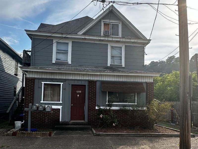 406 3rd Ave, New Brighton, PA 15066 - american foursquare style home featuring covered porch, brick siding, and roof with shingles