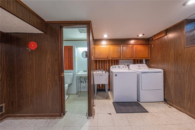 1445 Stanley Dr, Penn Hills, PA 15147 - laundry area with cabinet space, washing machine and clothes dryer, wooden walls, light floors, and recessed lighting