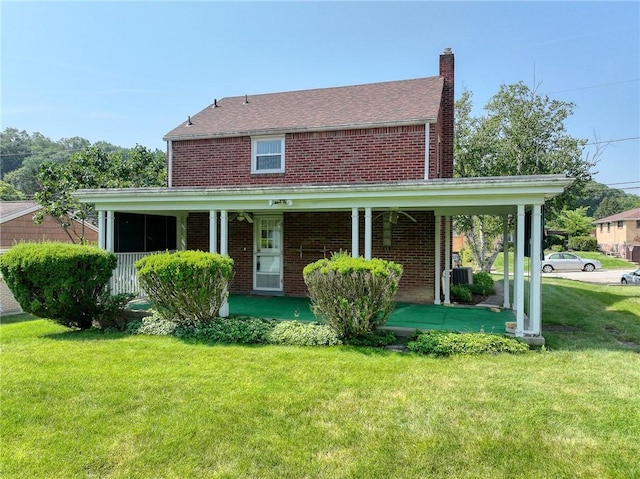 1445 Stanley Dr, Penn Hills, PA 15147 - view of front of property with brick siding, a chimney, a front lawn, and covered porch