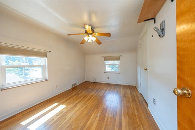 1445 Stanley Dr, Penn Hills, PA 15147 - spare room featuring light wood-style flooring, lofted ceiling, and a ceiling fan